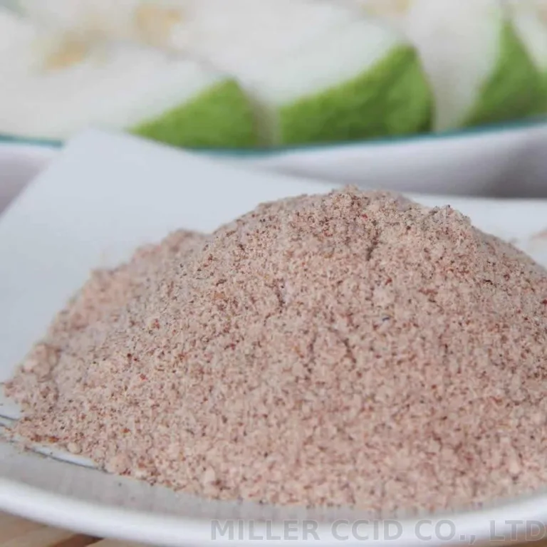 A white plate with a pile of brown powder resembling sour plum on it.