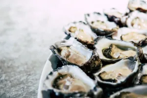 Fresh oysters on a white plate.