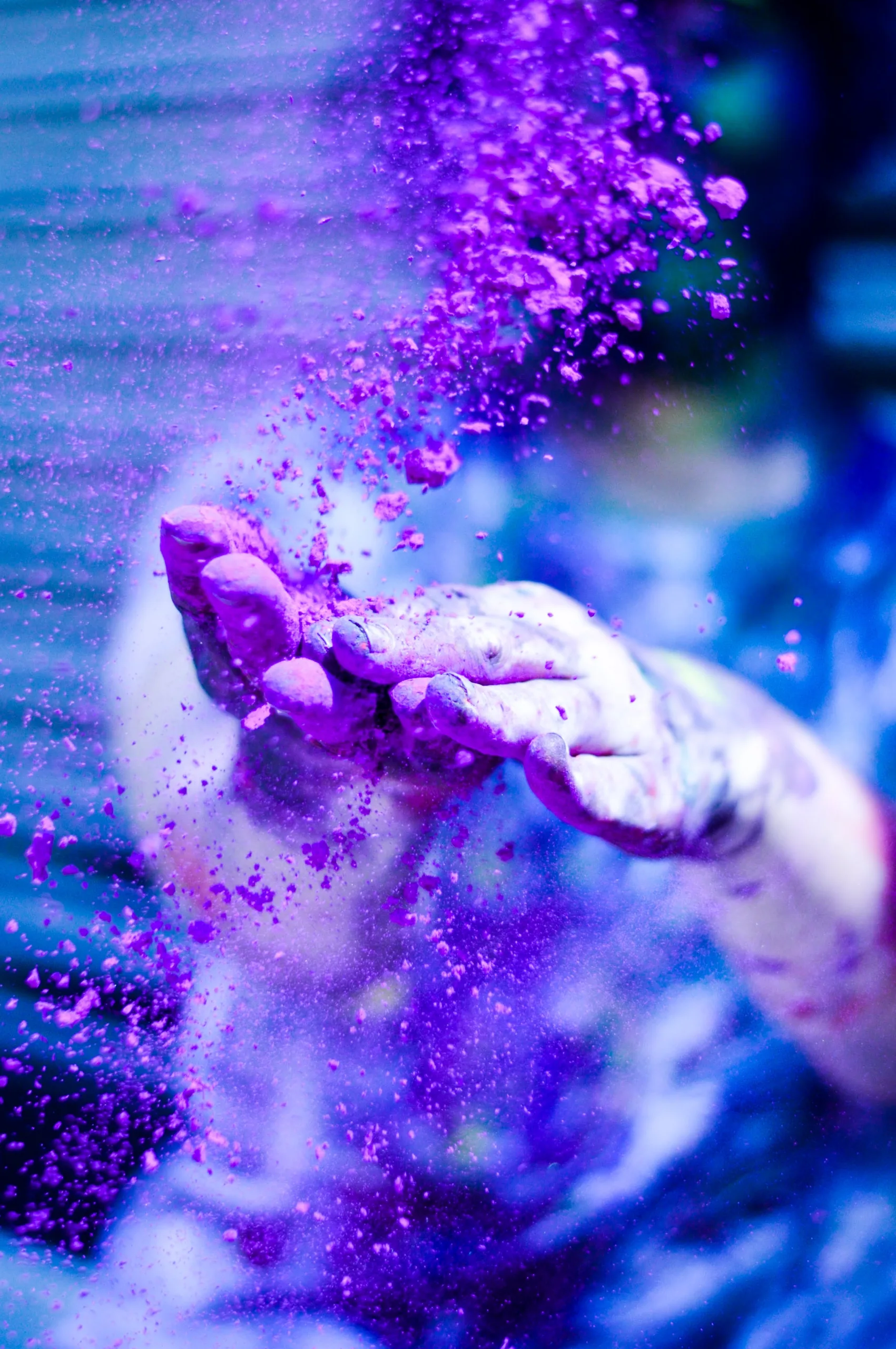 A person's hand is covered in purple powder.