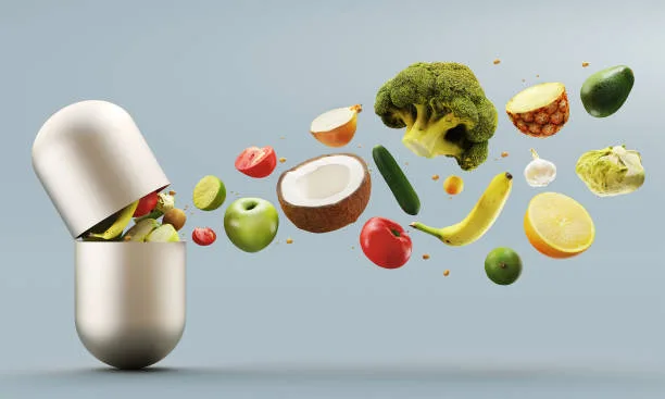 A pill with fruits and vegetables coming out of it.
