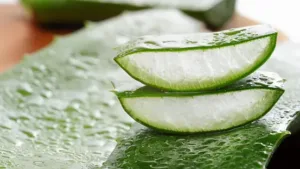 A slice of aloe vera on a cutting board.