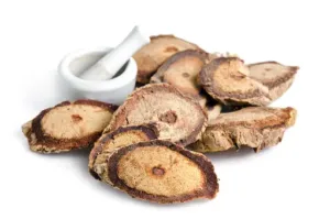 A pile of slices of ginseng on a white background.