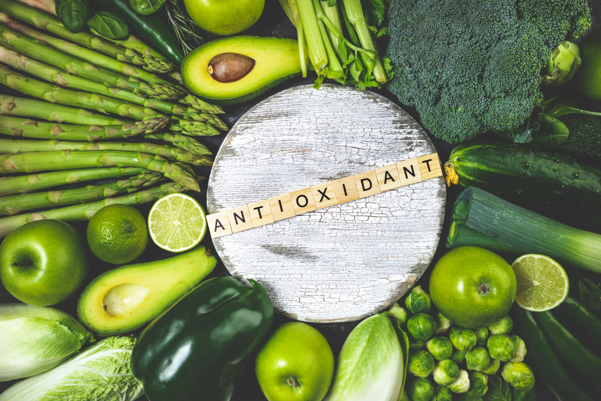 Green vegetables with antioxidant text on board.