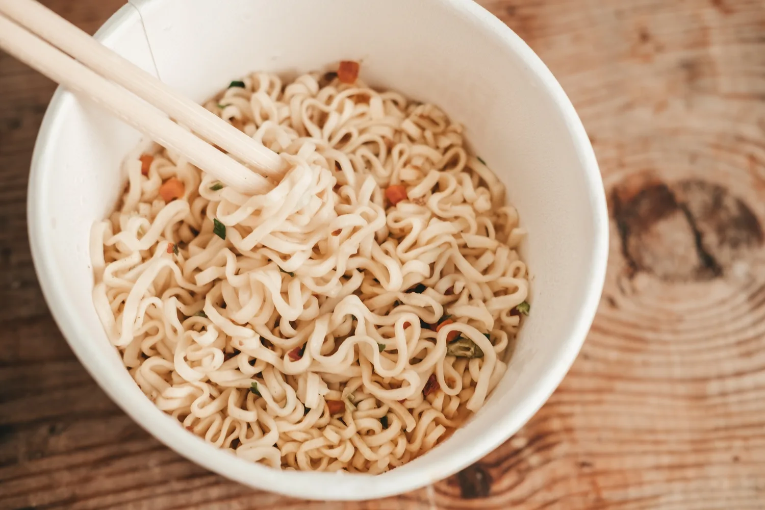 Instant noodles in cup with chopsticks