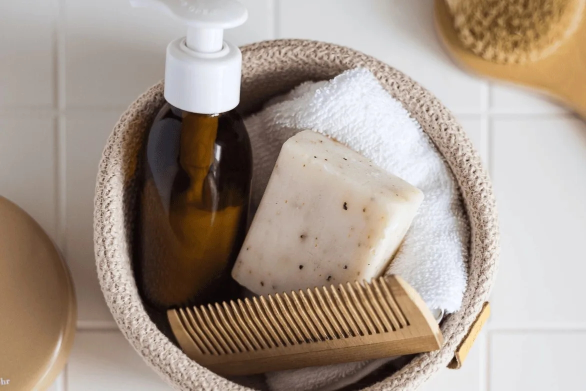 Spa essentials: soap, bottle, comb in basket