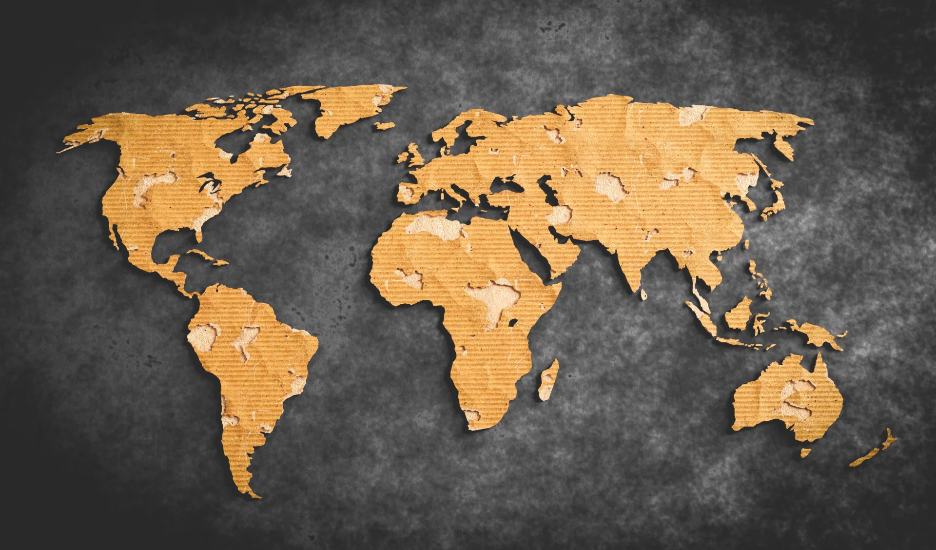 Cardboard world map on dark background