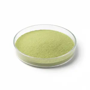 Green powder in a round glass dish.