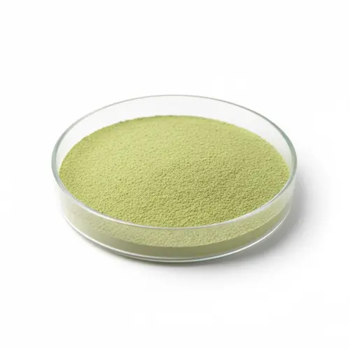 Green powder in a round glass dish.