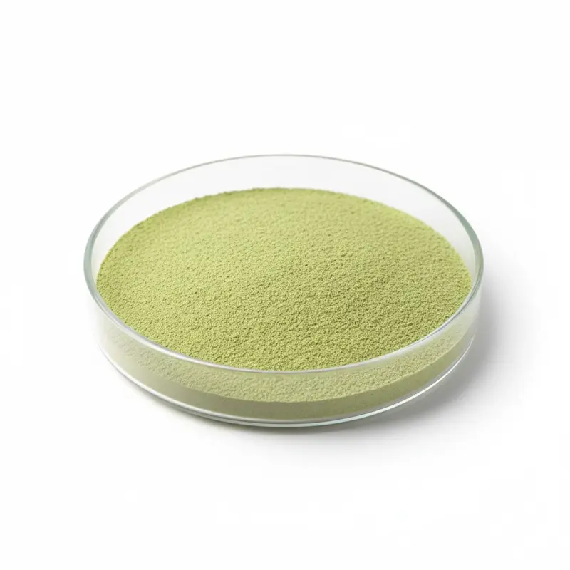 Green powder in a round glass dish.
