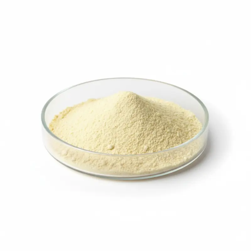 Yellow powder in a clear petri dish on white background.