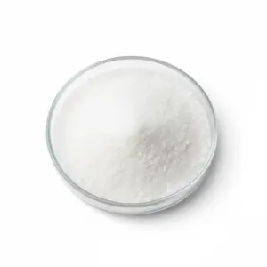 Bowl of granular white sugar on white background.