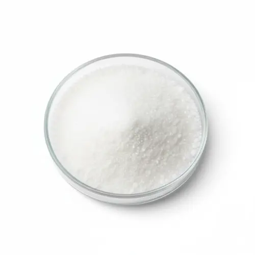 Bowl of granular white sugar on white background.