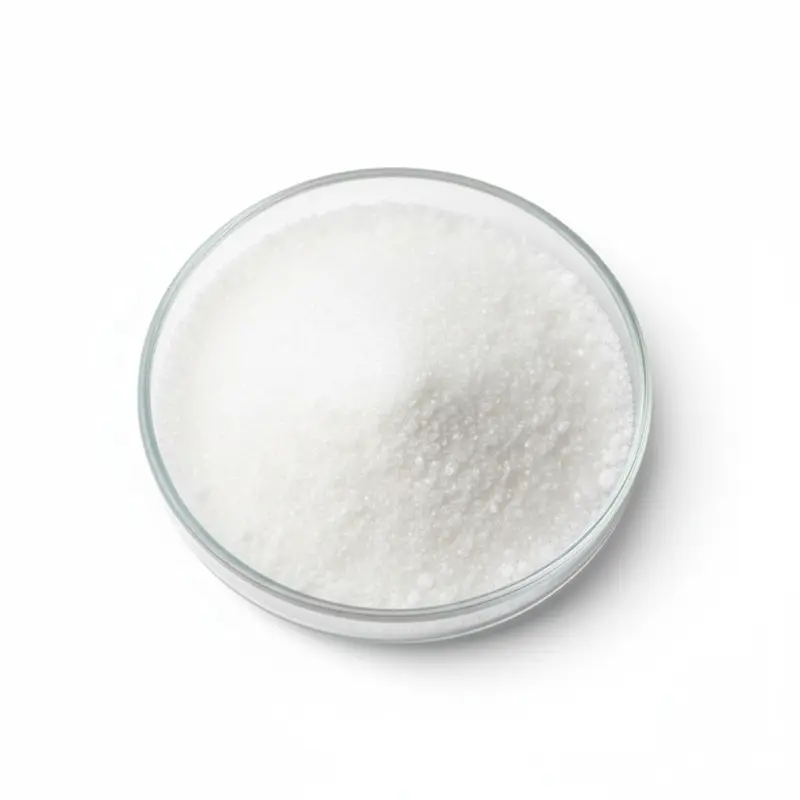 Bowl of granular white sugar on white background.