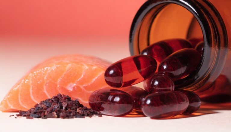 Astaxanthin softgel capsules with salmon and algae, editorial photography