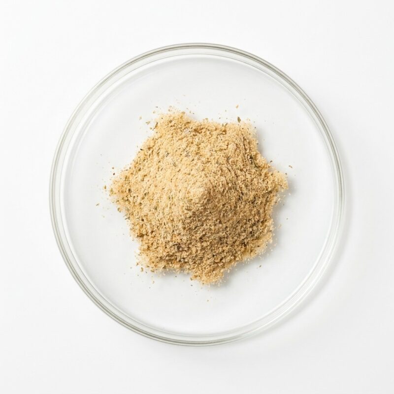 chicken-seasoning-powder Tan beige chicken seasoning flavor powder in a glass petri dish