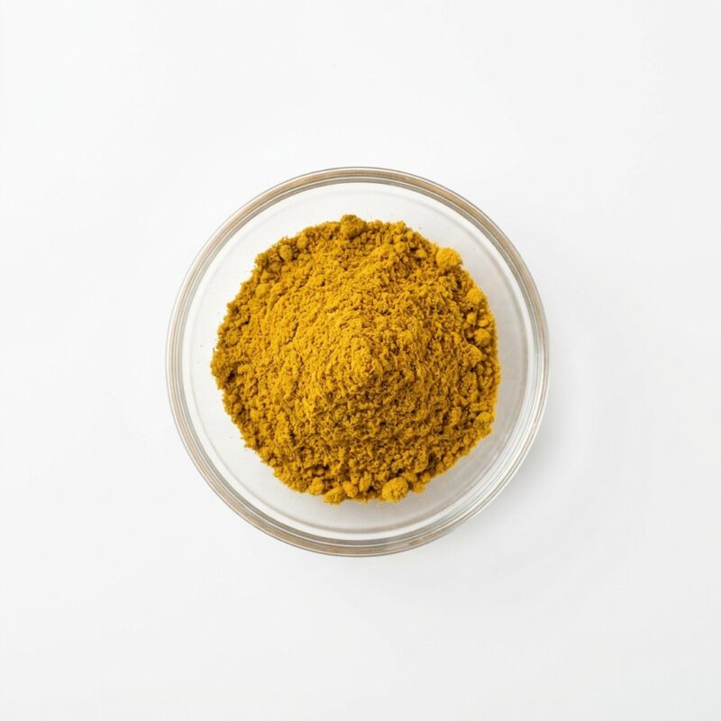 curcumin-powder-extract Vivid orange curcumin powder extract in a glass petri dish