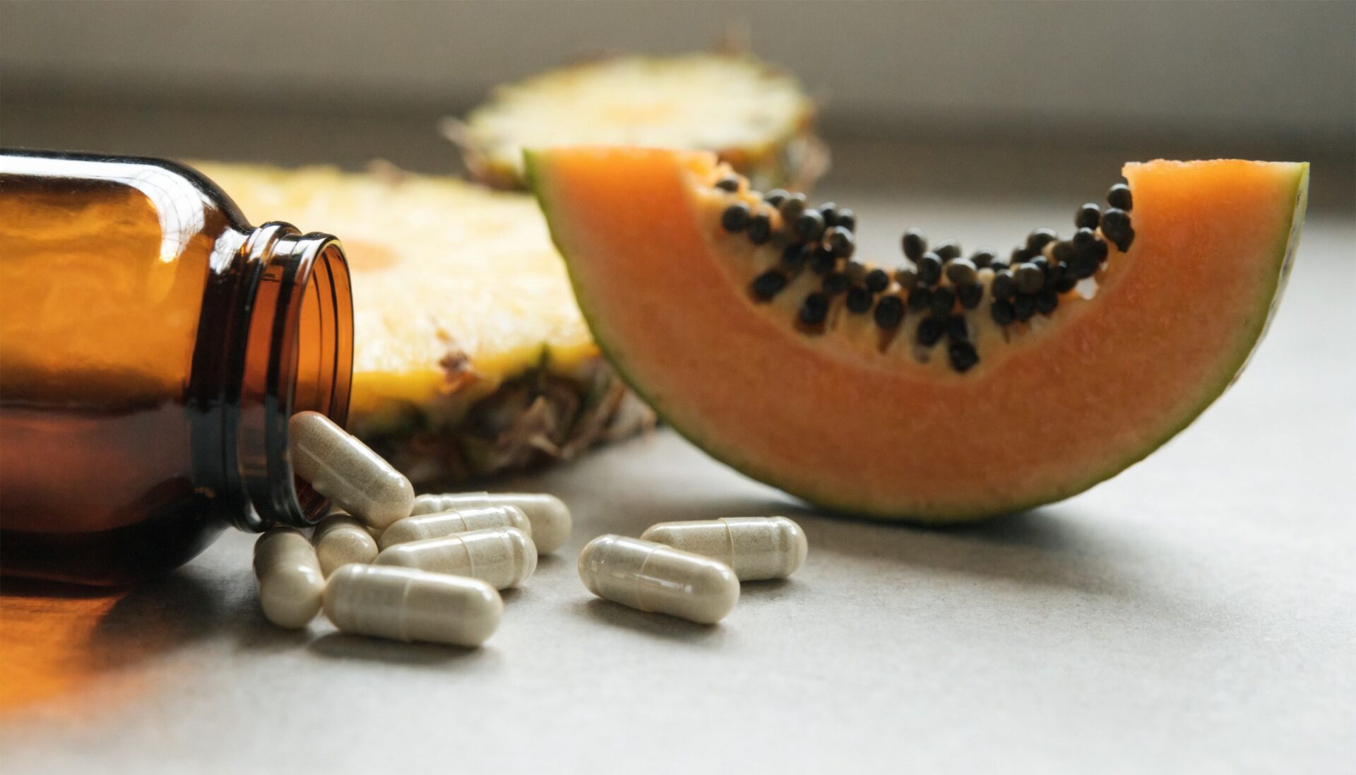Digestive enzyme capsules with papaya and pineapple, editorial food photography