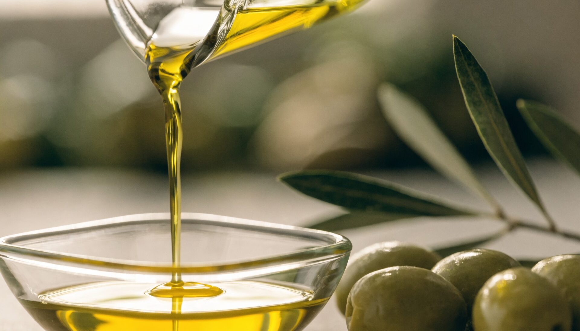 Extra virgin olive oil with fresh olives, editorial food photography