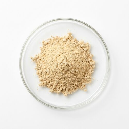 Light tan ginger root extract powder in a glass petri dish