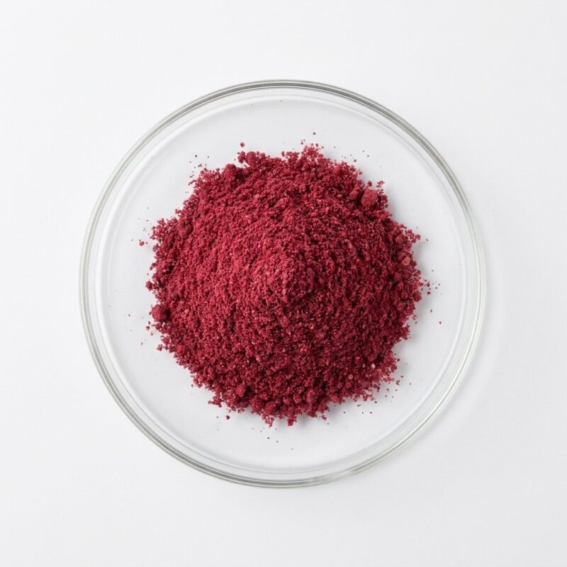 PSD Pomegranate - Natural Pomegranate Juice Powder Dark red pomegranate fruit powder in a glass petri dish