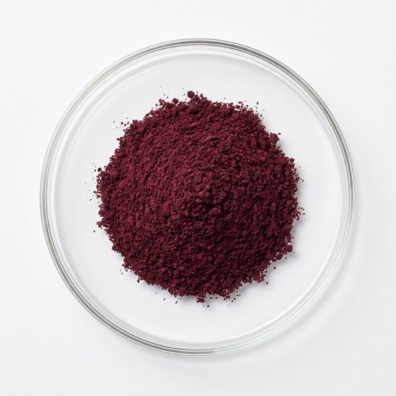 hibiscus-extract-powder Dark red hibiscus flower extract powder in a glass petri dish