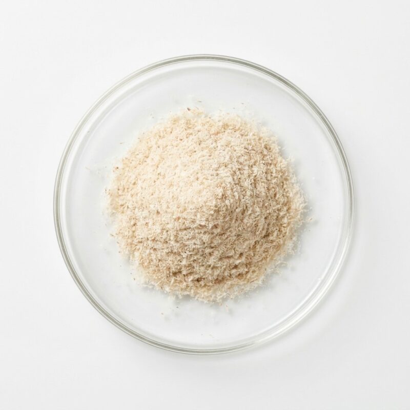 psyllium-husk-powder Pale beige psyllium husk fiber powder in a glass petri dish