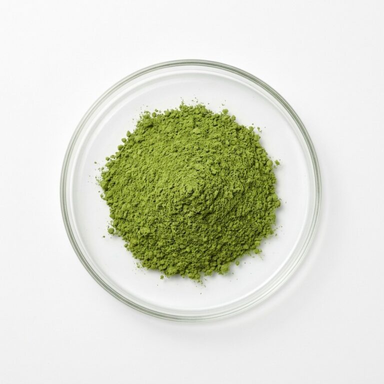 Green senna leaf extract powder in a glass petri dish