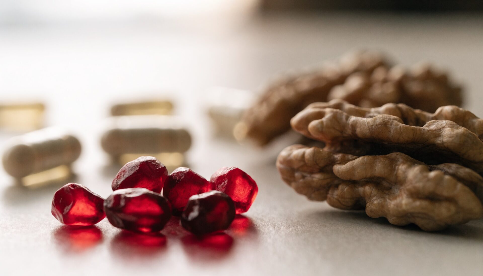 Pomegranate arils and walnuts, urolithin A precursor foods, editorial photography